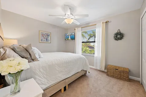 a spacious bedroom with a bed couch and window