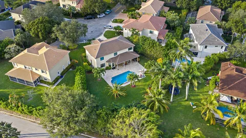 a view of a house with swimming pool and sitting area