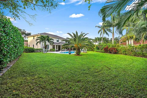 a view of an outdoor dining space with furniture and garden