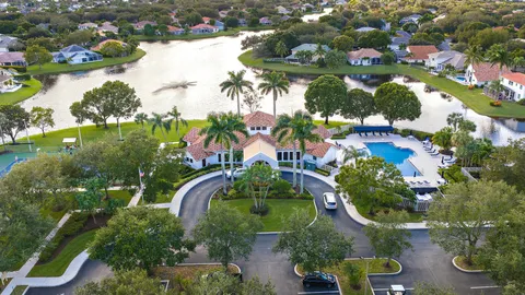 a view of a swimming pool with a yard and sitting area