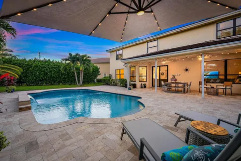a backyard of a house with a garden and outdoor seating
