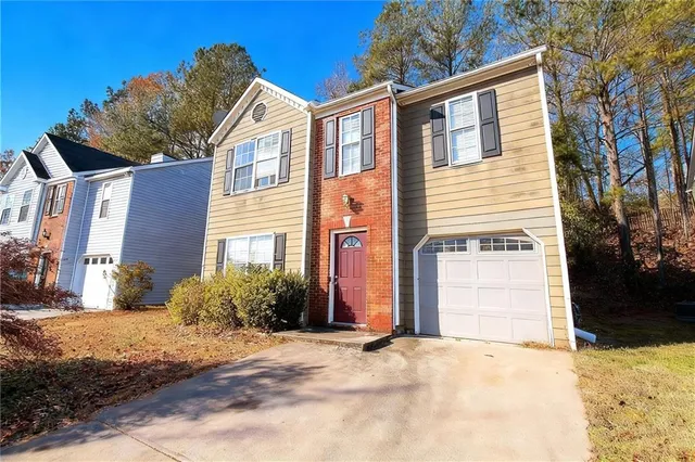 a front view of a house with a yard