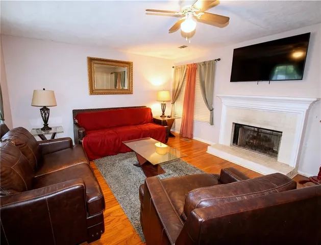 a bathroom with a granite countertop toilet and a sink