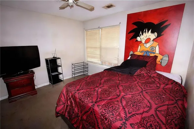 a bedroom with a bed and cabinet