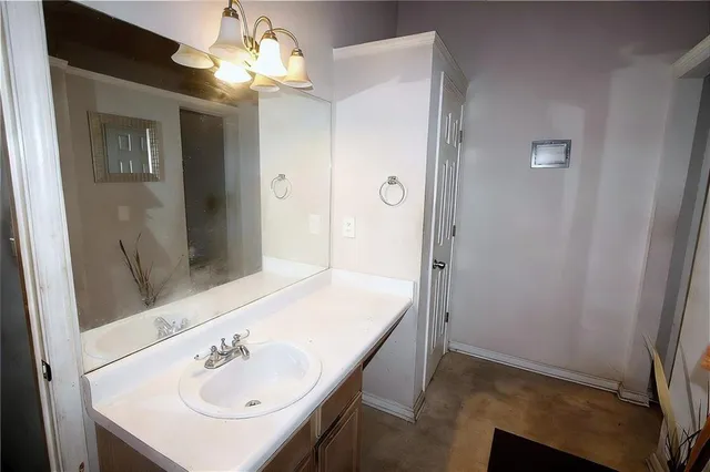 a bathroom with a sink and mirror with toilet