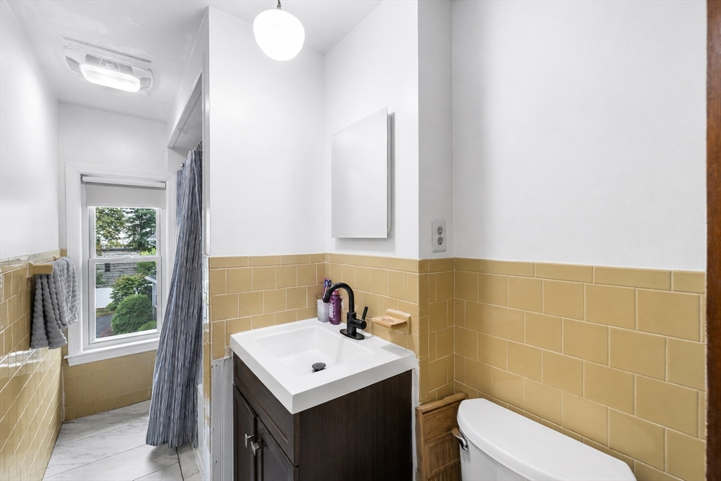 4 State Street, Unit 4 Milford, MA 01757 - Photo 17 of 23 a bathroom with a sink a toilet and a mirror