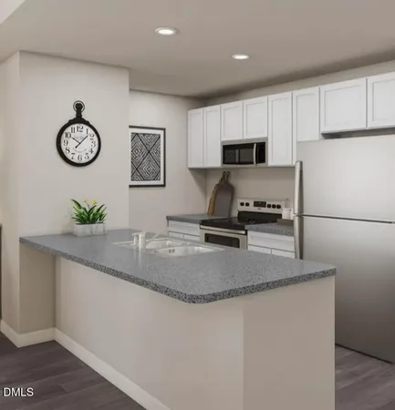 a kitchen with stainless steel appliances granite countertop a sink a refrigerator and a stove