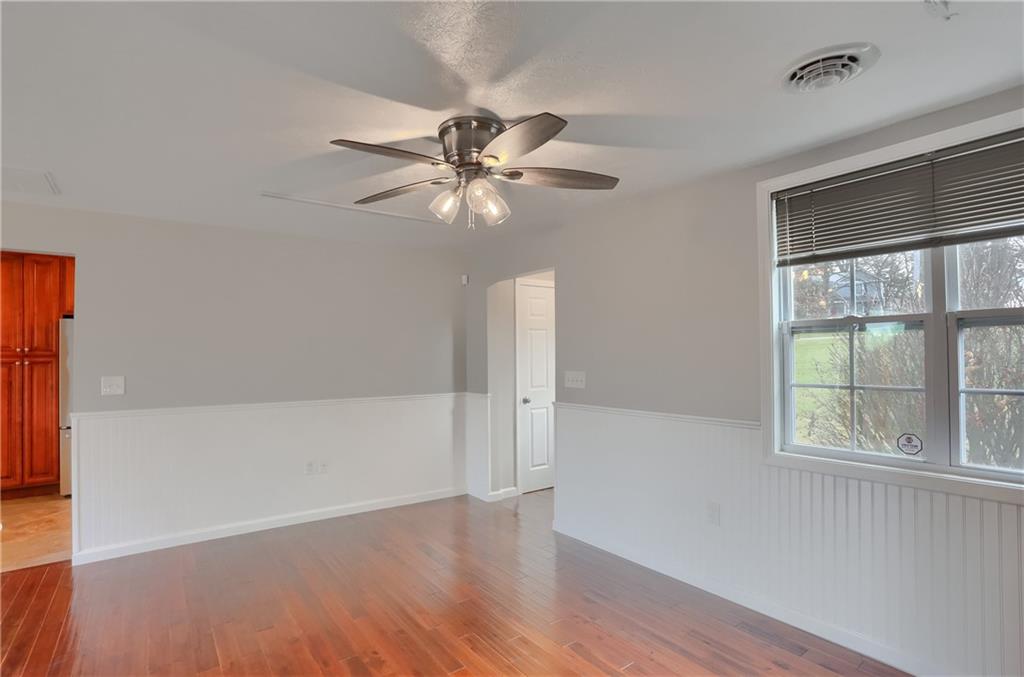 110 Oakville Road Beaver Falls, PA 15010 - Photo 10 of 48 A ceiling fan, wainscoting and hardwood flooring are highlights of the family room.