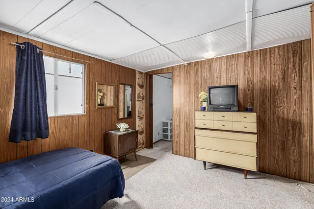 a room with a bed and furniture