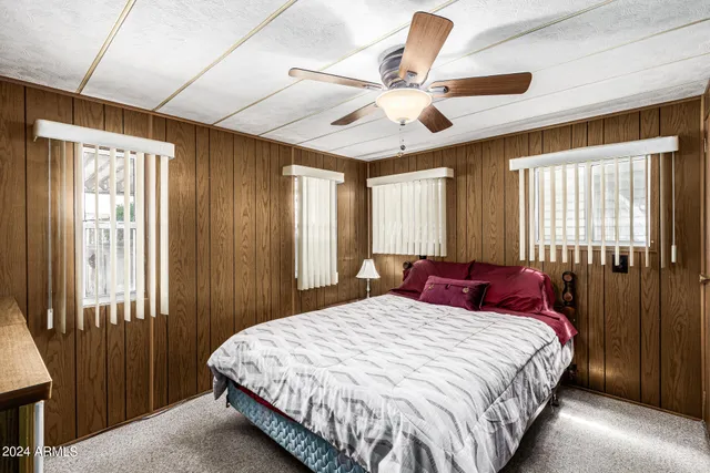 a bedroom with a large bed and a chandelier