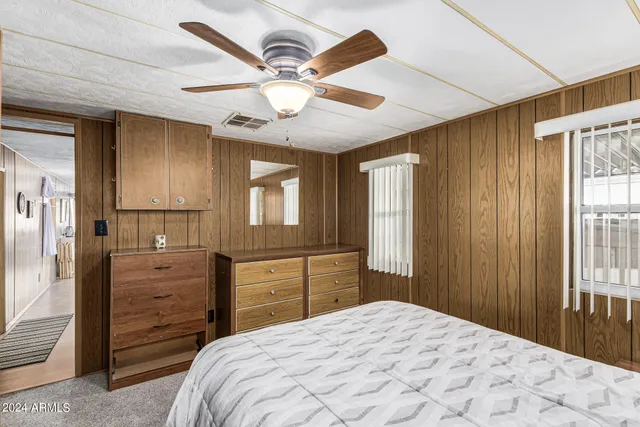 a bedroom with a bed and a dresser