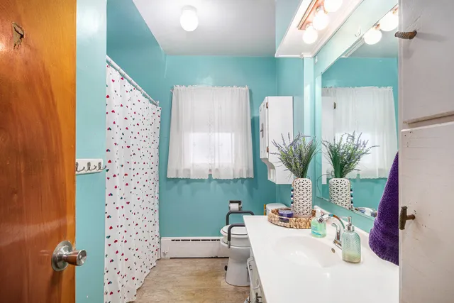 a bathroom with a sink a toilet and a mirror