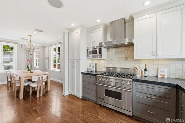 a bedroom with a large bed and a potted plant