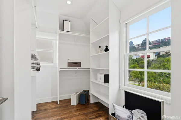 a bedroom with a large bed and a desk