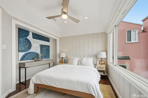 a bedroom with a large bed and a chandelier