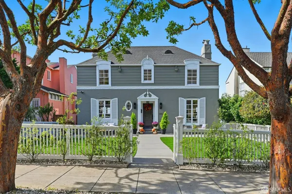a front view of a house with a garden