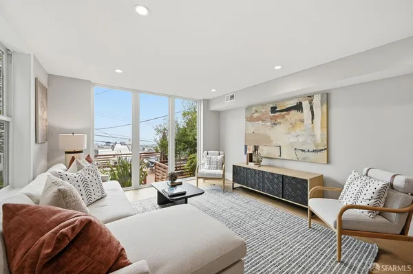 a view of a roof deck with table and chairs and wooden floor