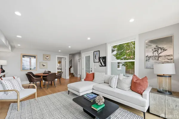 a view of a roof deck with couches and wooden floor