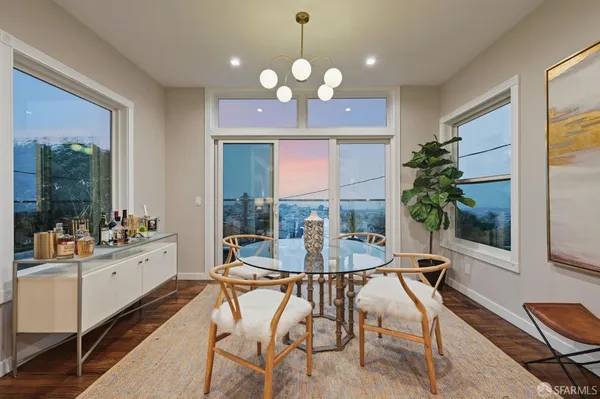a view of a dining room with furniture a livingroom and chandelier