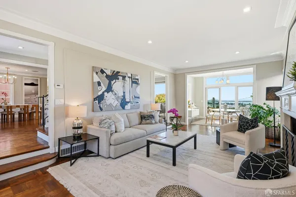 a living room with furniture rug and a large window