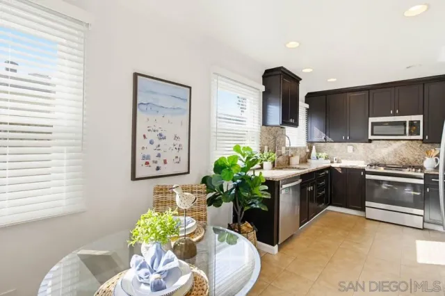 a kitchen with a sink a stove and cabinets