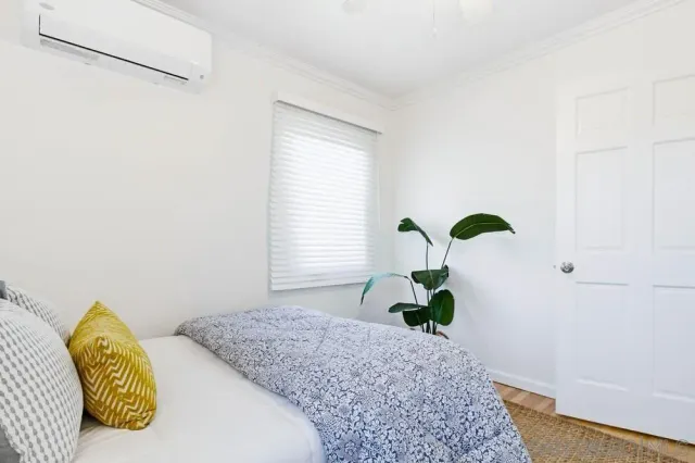 a backyard of a house with yard fountain and outdoor seating