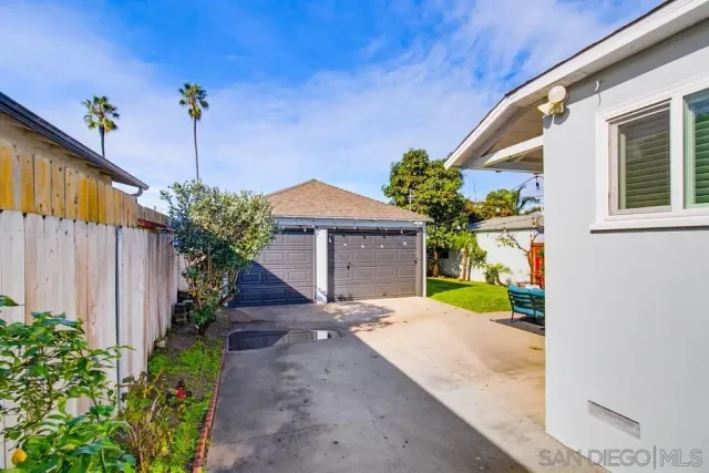a backyard of a house with outdoor seating