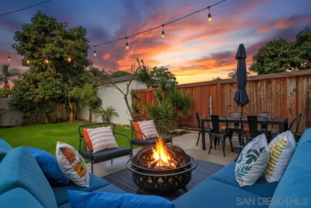 a backyard of a house with outdoor seating