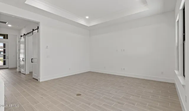 an empty room with windows and closet