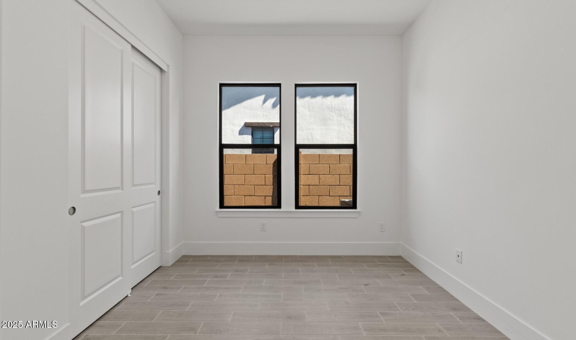20307 West Roma Avenue Buckeye, AZ 85396 - Photo 13 of 48 an empty room with windows and closet