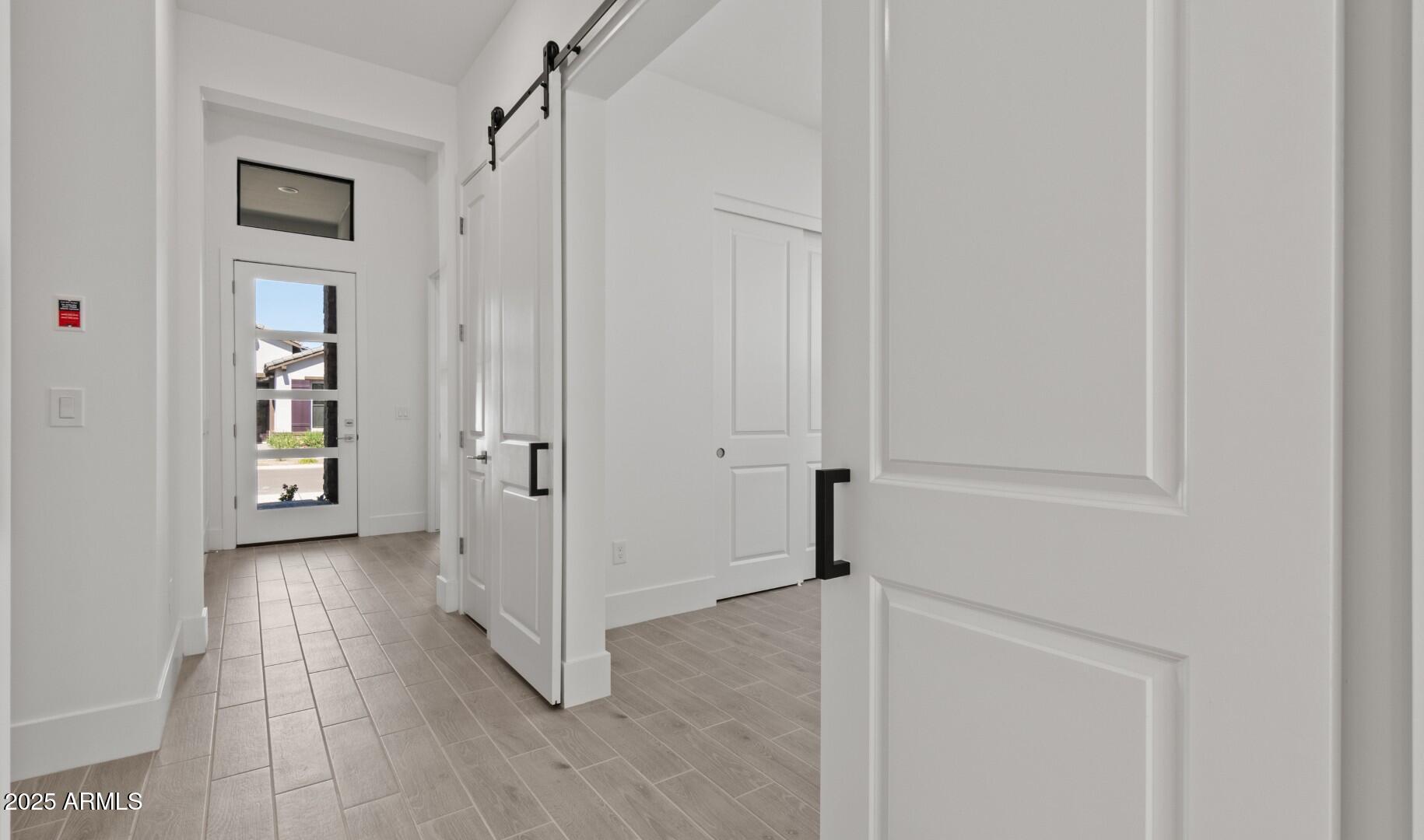 20307 West Roma Avenue Buckeye, AZ 85396 - Photo 14 of 48 a view of a hallway with wooden floor and closet