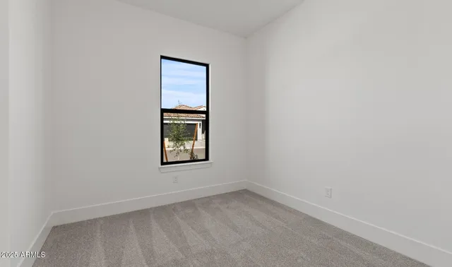 a view of a hallway with wooden floor and closet