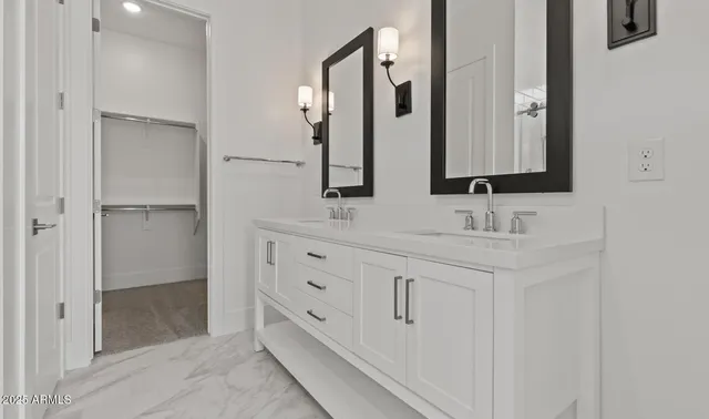 a bathroom with double sink and a mirror