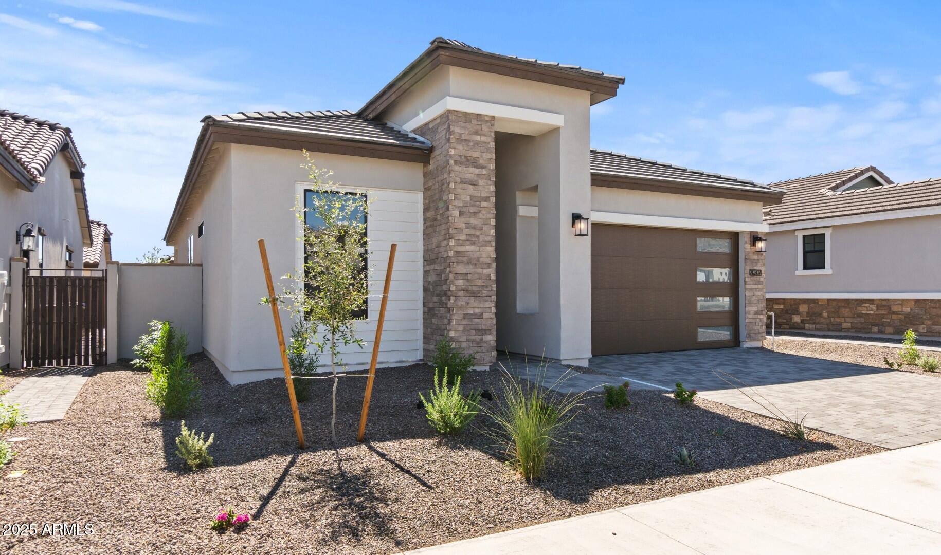 20307 West Roma Avenue Buckeye, AZ 85396 - Photo 2 of 48 a front view of a house with garden