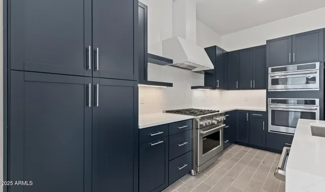 a kitchen with granite countertop a sink cabinets and window