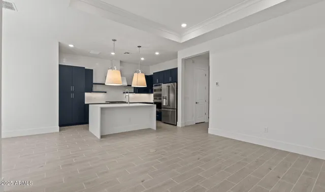 a large white kitchen with a large window