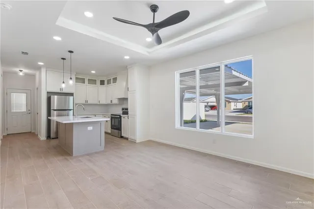 a large kitchen with a large window and stainless steel appliances