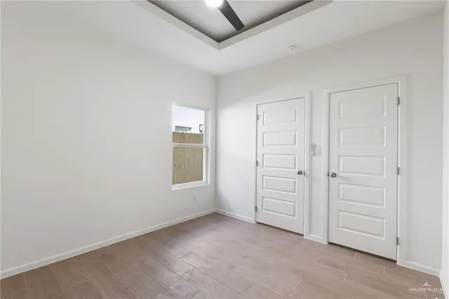an empty room with windows and closet