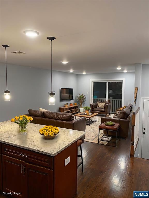 a kitchen with sink stove and chairs