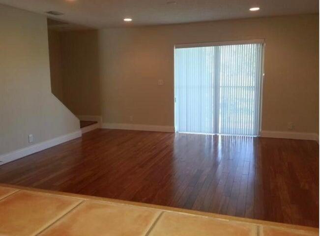 5267 Pine Meadows Road Lake Worth, FL 33463 - Photo 17 of 17 an empty room with wooden floor