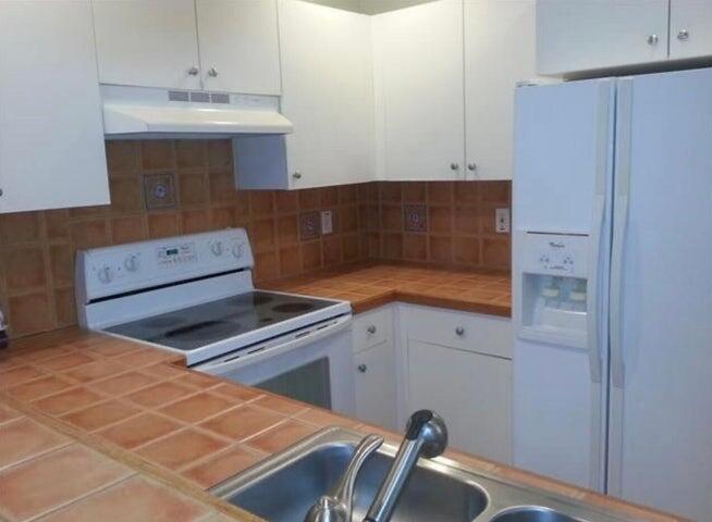 5267 Pine Meadows Road Lake Worth, FL 33463 - Photo 2 of 17 a kitchen with a sink cabinets and utility
