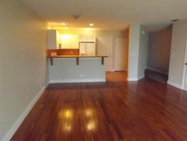 5267 Pine Meadows Road Lake Worth, FL 33463 - Photo 3 of 17 a view of a kitchen with wooden floor and a window