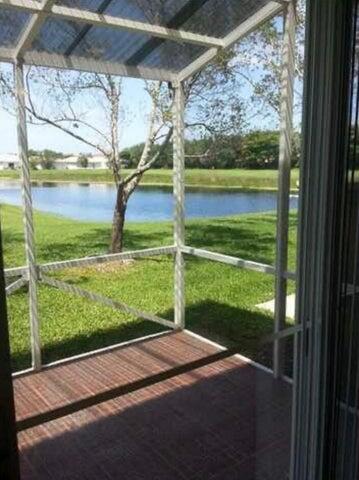 5267 Pine Meadows Road Lake Worth, FL 33463 - Photo 4 of 17 a view of a porch with a yard