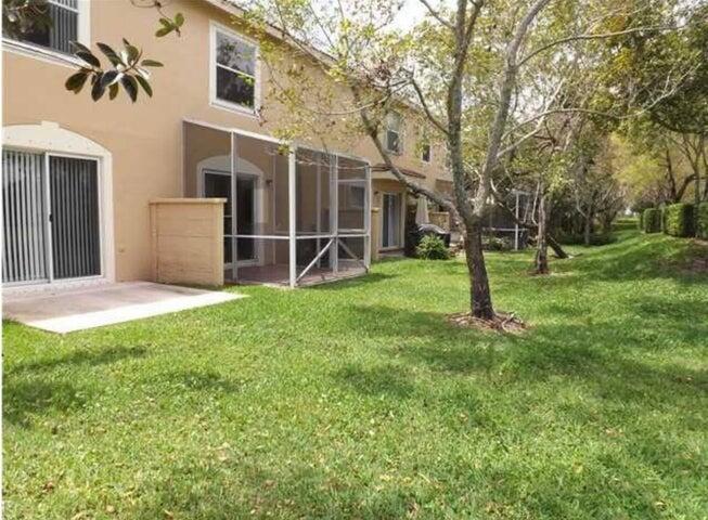 5267 Pine Meadows Road Lake Worth, FL 33463 - Photo 6 of 17 a view of a backyard with a tree