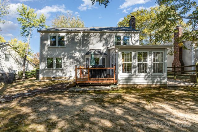 a view of a house with a large window and plants