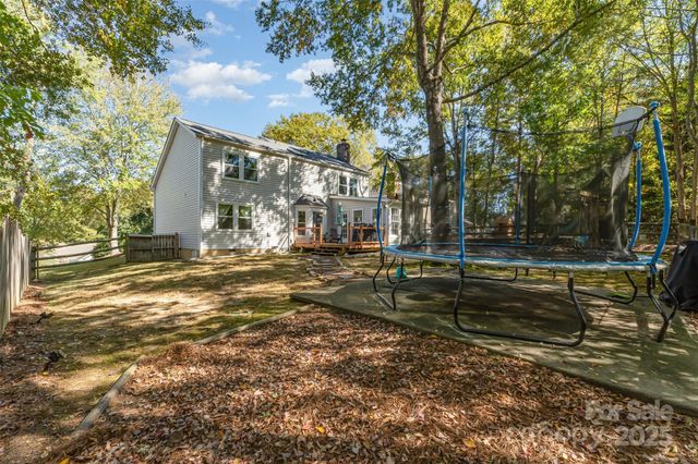 a view of a yard with large trees