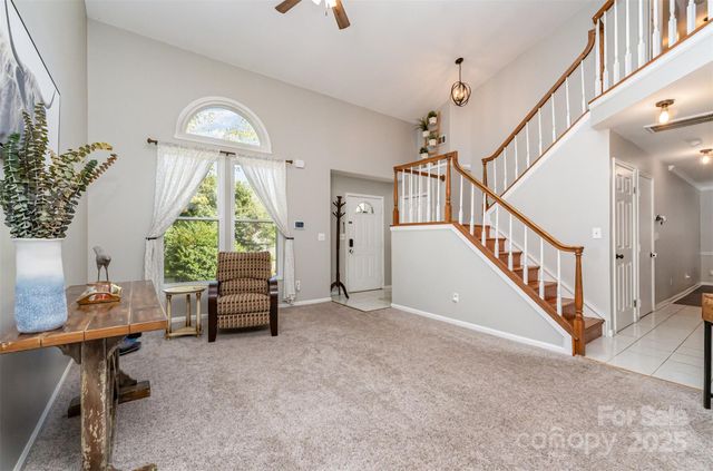 a view of hall way with furniture and a window