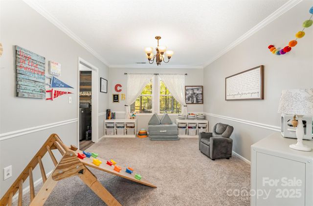 a living room with furniture a flat screen tv and a couch