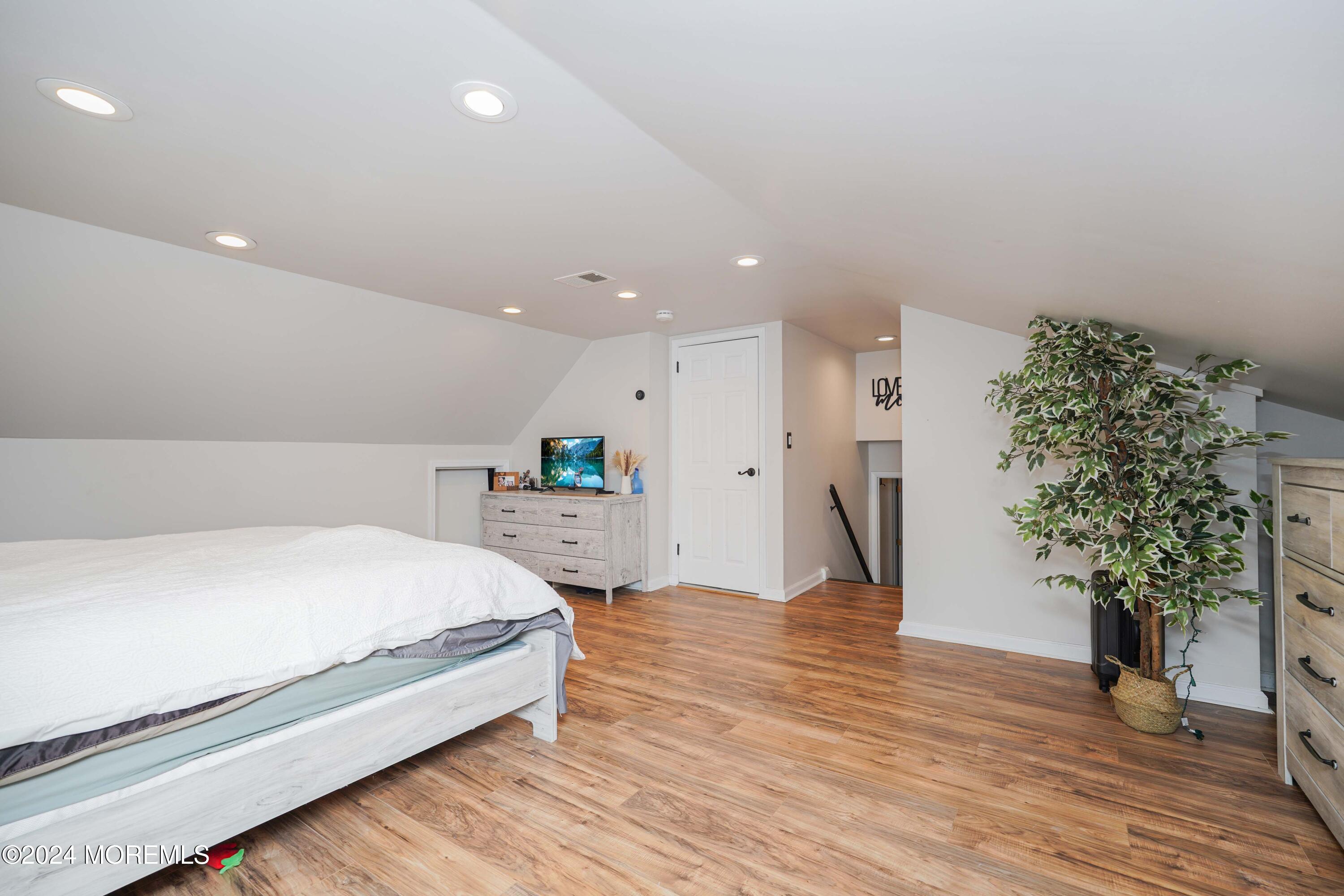 13 Bartle Road Somerset, NJ 08873 - Photo 16 of 26 a spacious bedroom with a bed and a potted plant