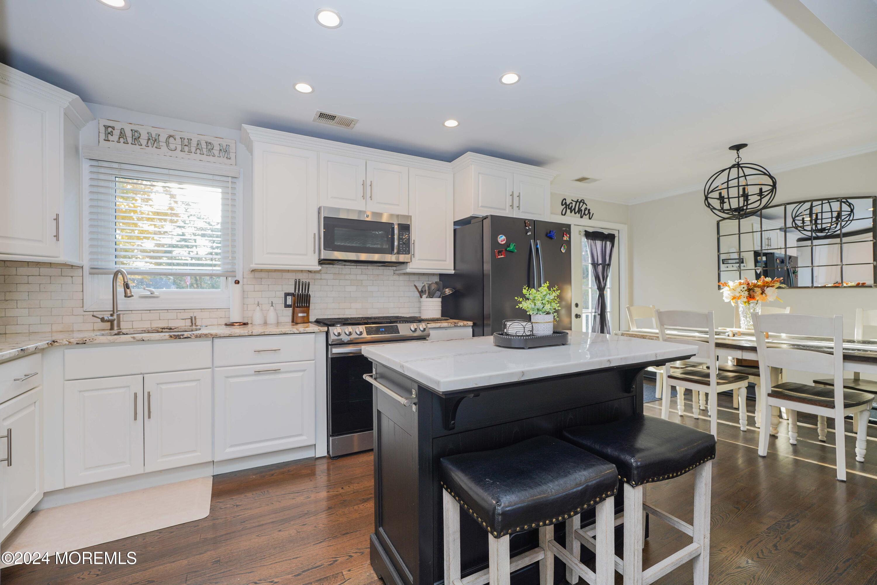 13 Bartle Road Somerset, NJ 08873 - Photo 8 of 26 a kitchen with sink cabinets and wooden floor